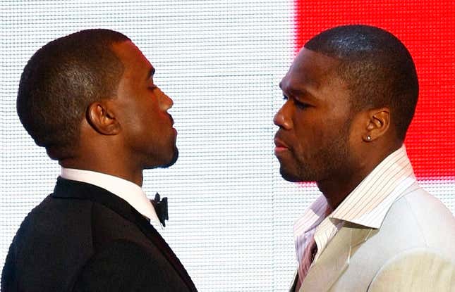 50 Cent and Kanye West stand face to face. 